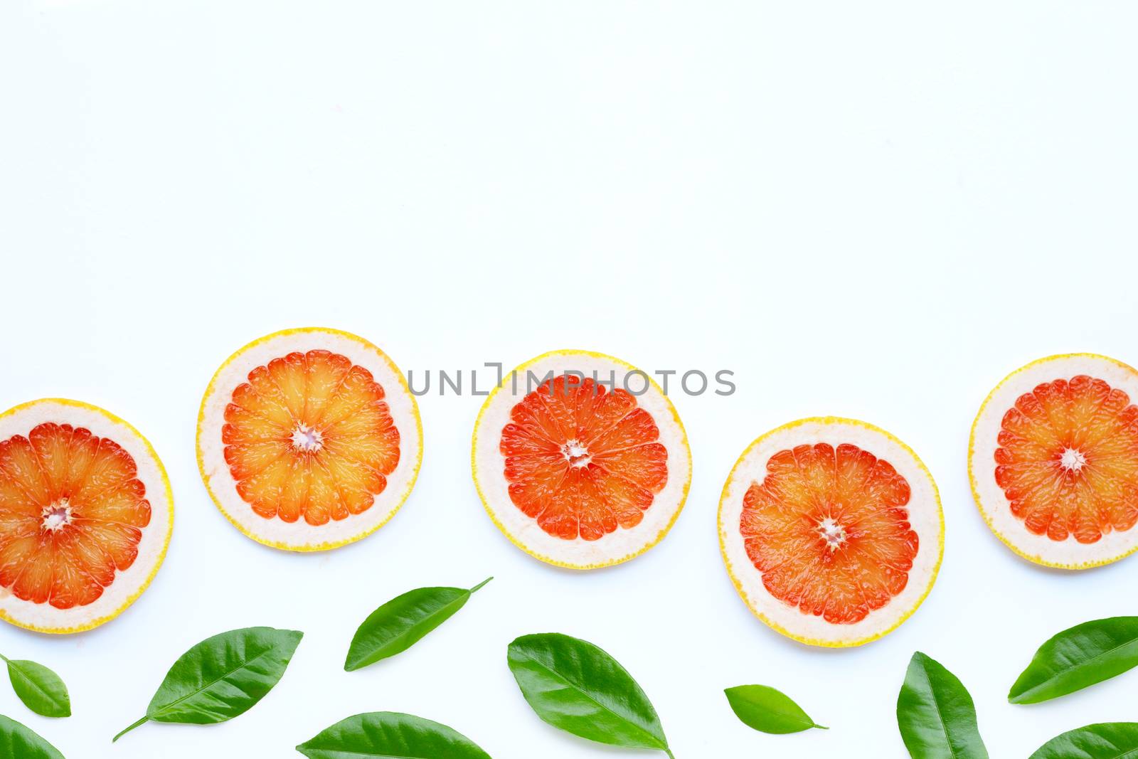 High vitamin C. Juicy grapefruit slices on white background.