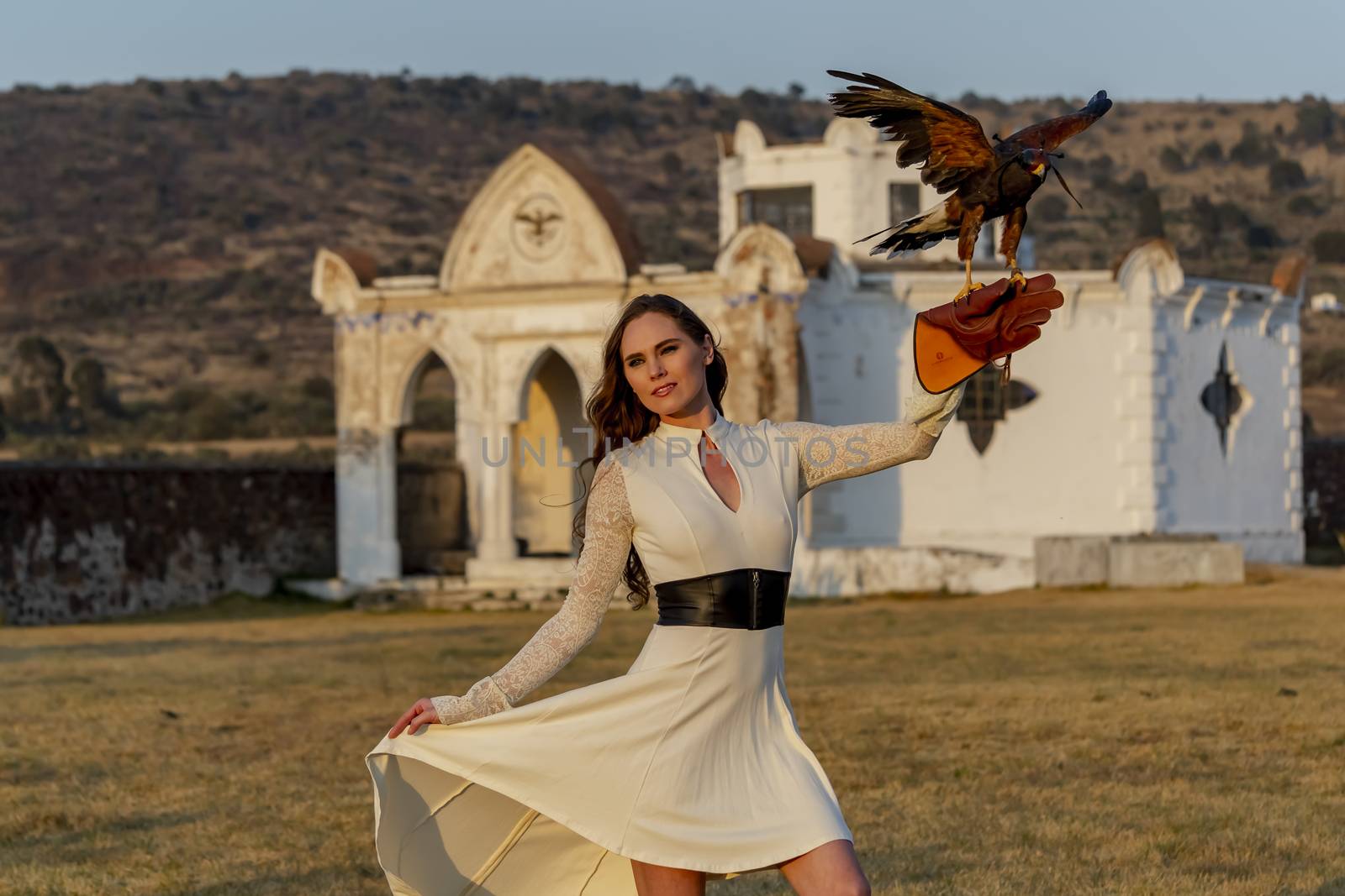 A Lovely Hispanic Brunette Model Poses Outdoors With A Falcon At A Hacienda by actionsports
