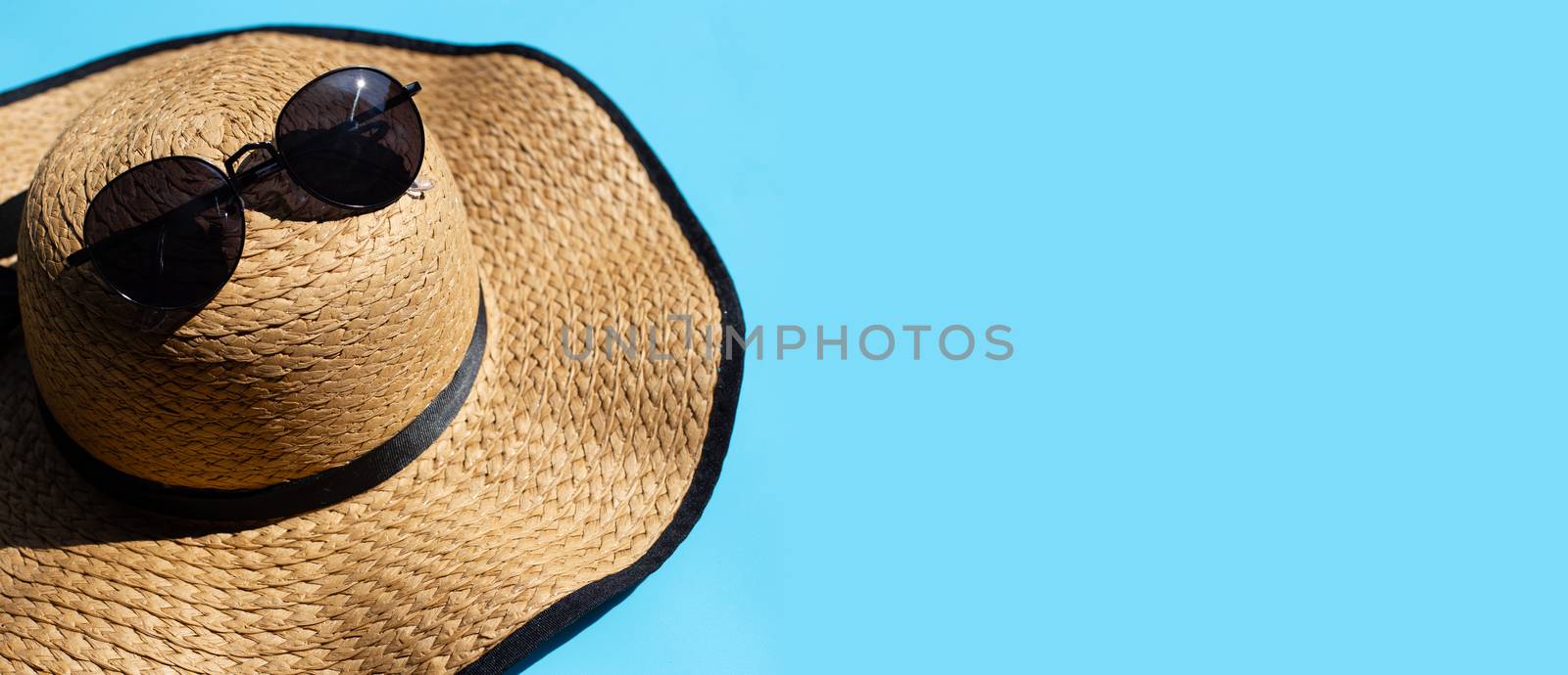 Hat with sunglasses on blue background. Enjoy summer holiday con by Bowonpat