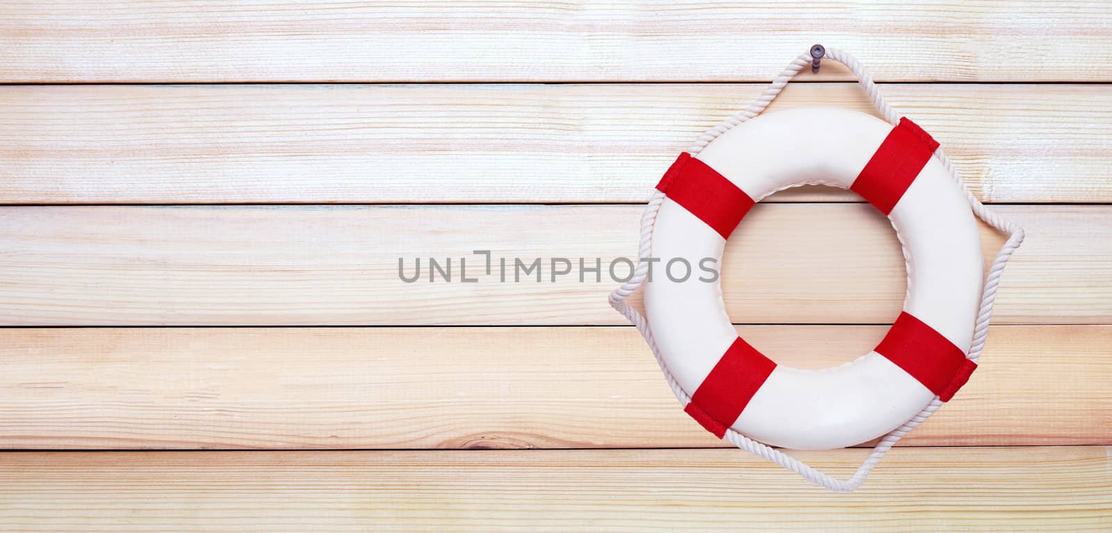 Lifebuoy on wooden background.  by Bowonpat