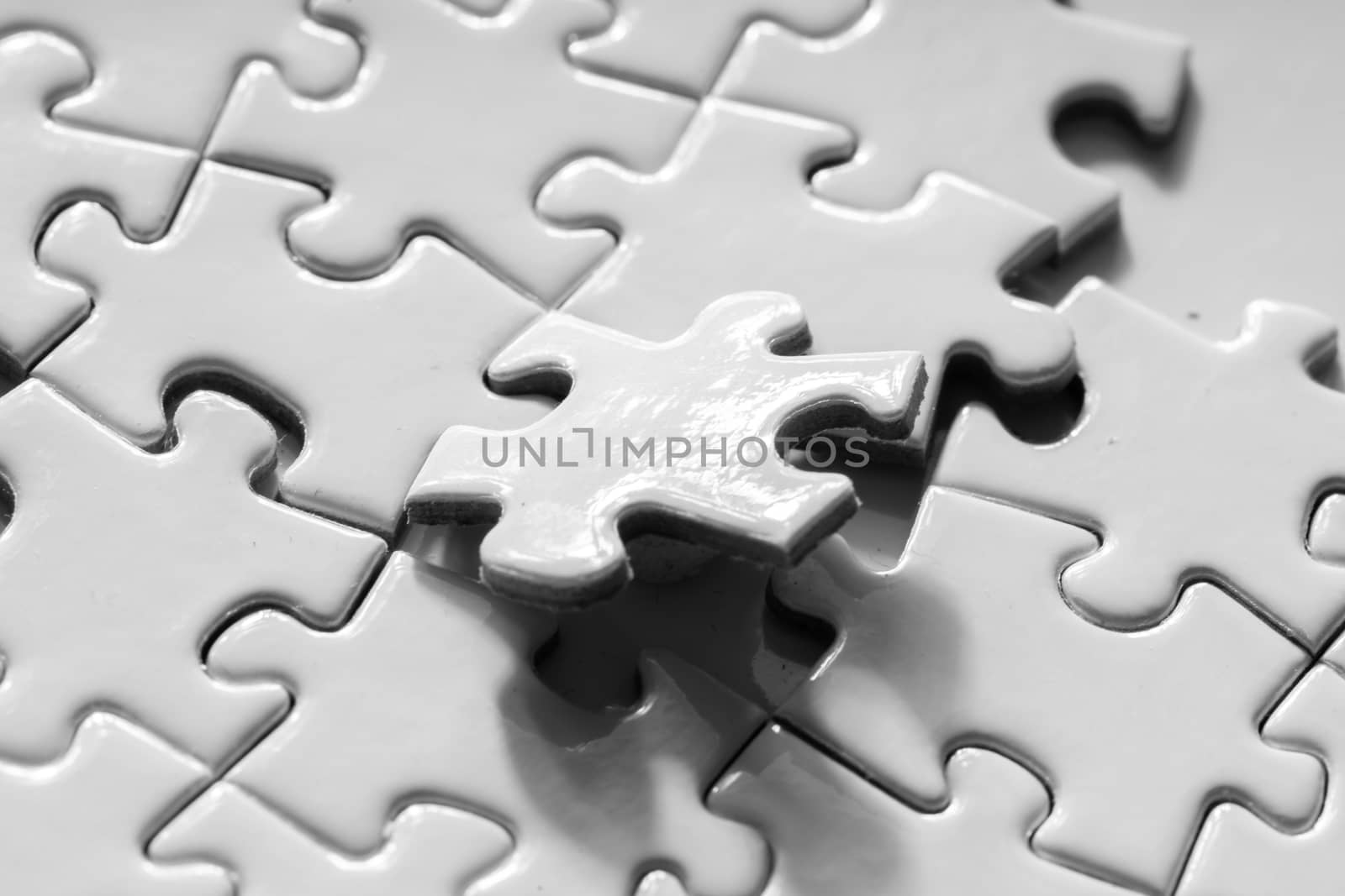 Close up of white jigsaw for business concept by Alicephoto