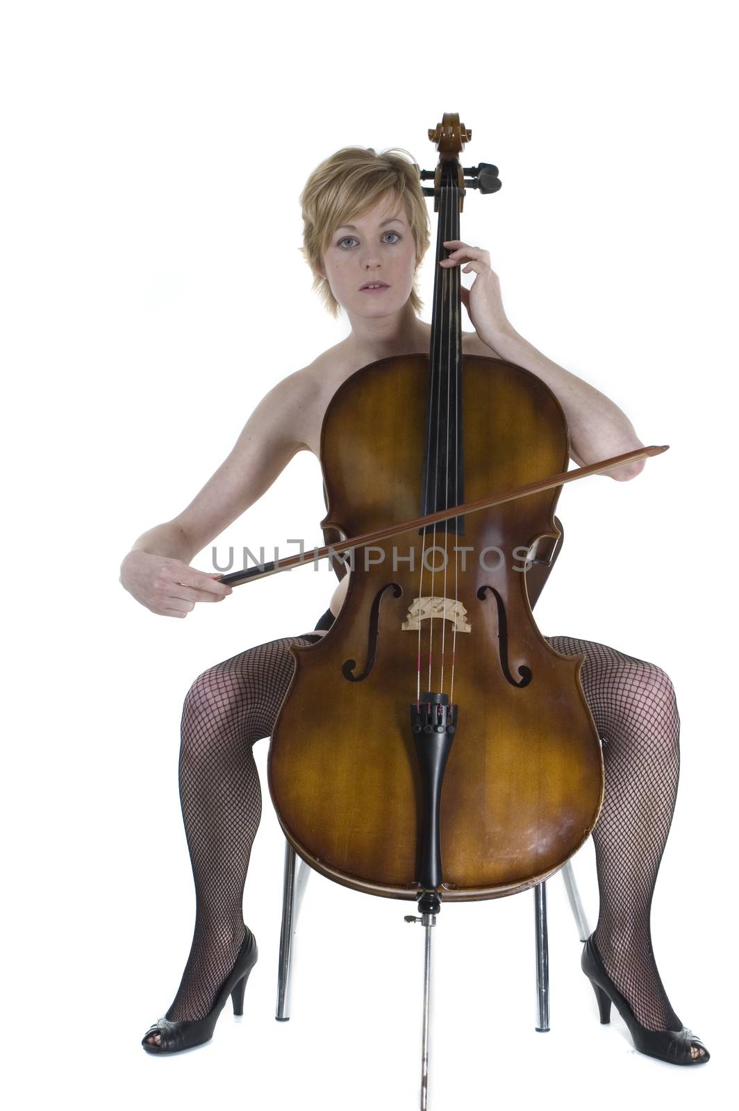 An attractive blonde woman sitting playing the cello