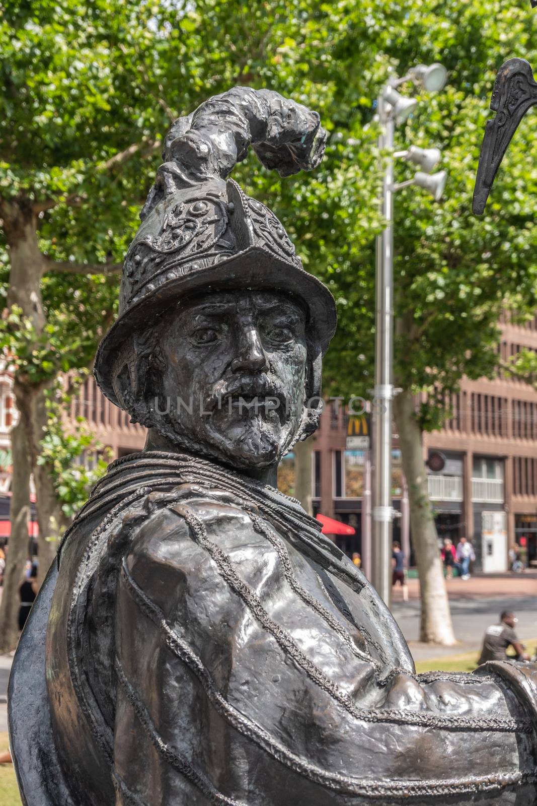 Amsterdam, the Netherlands - July 1, 2019: De Nachtwacht compostion of statues on Rembrandtplein. closeup of chest and head of soldier, warrior statue with feathered helmet.