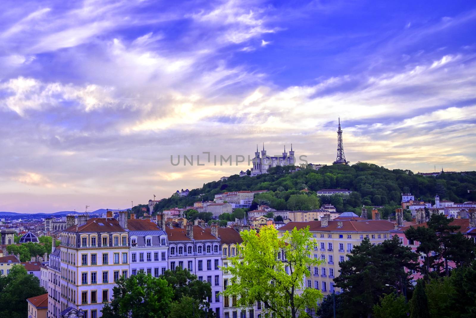 Lyon, France and the Basilica of Notre-Dame de Fourvière at sunset.