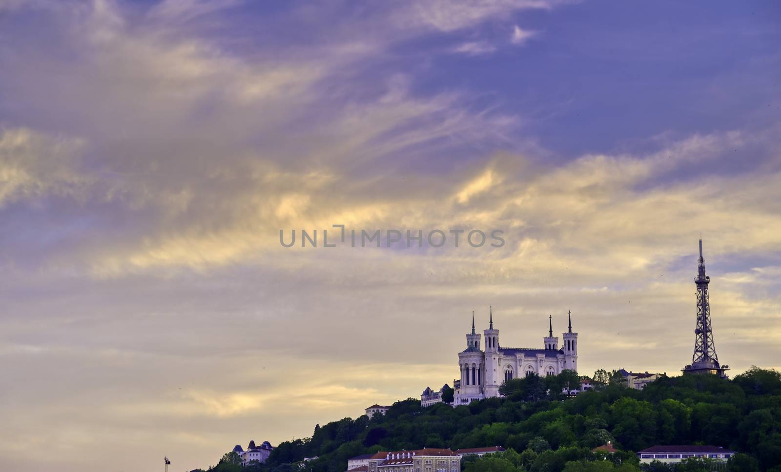 Lyon, France and the Basilica of Notre-Dame de Fourvière at sunset.