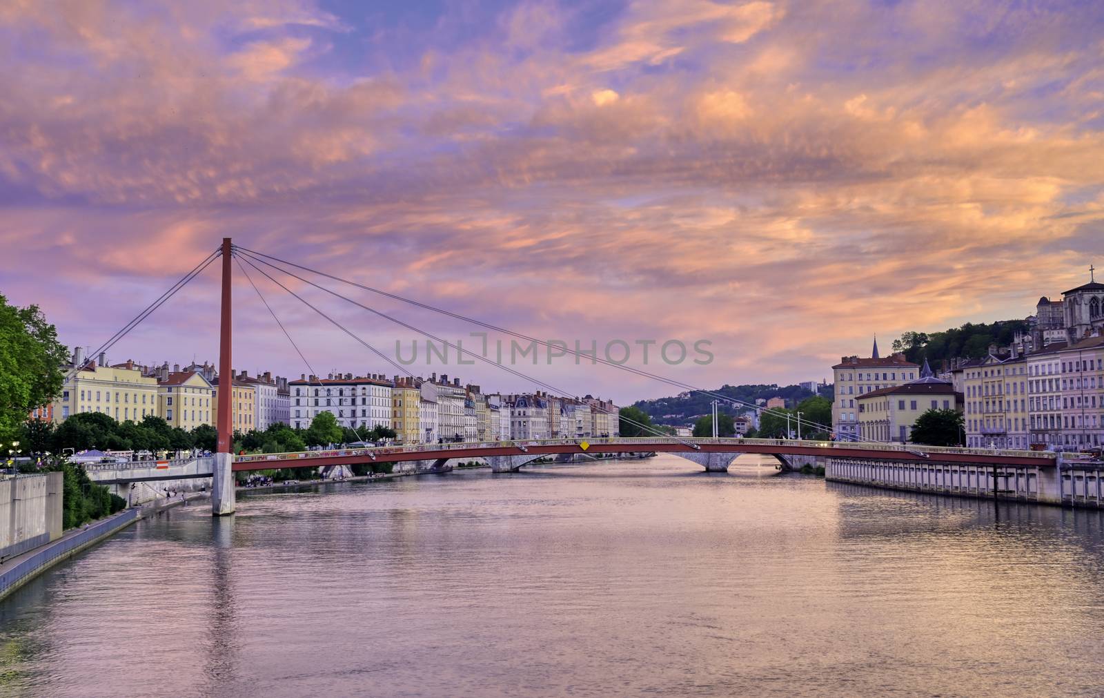 A view of Lyon, France along the Saône river at sunset.