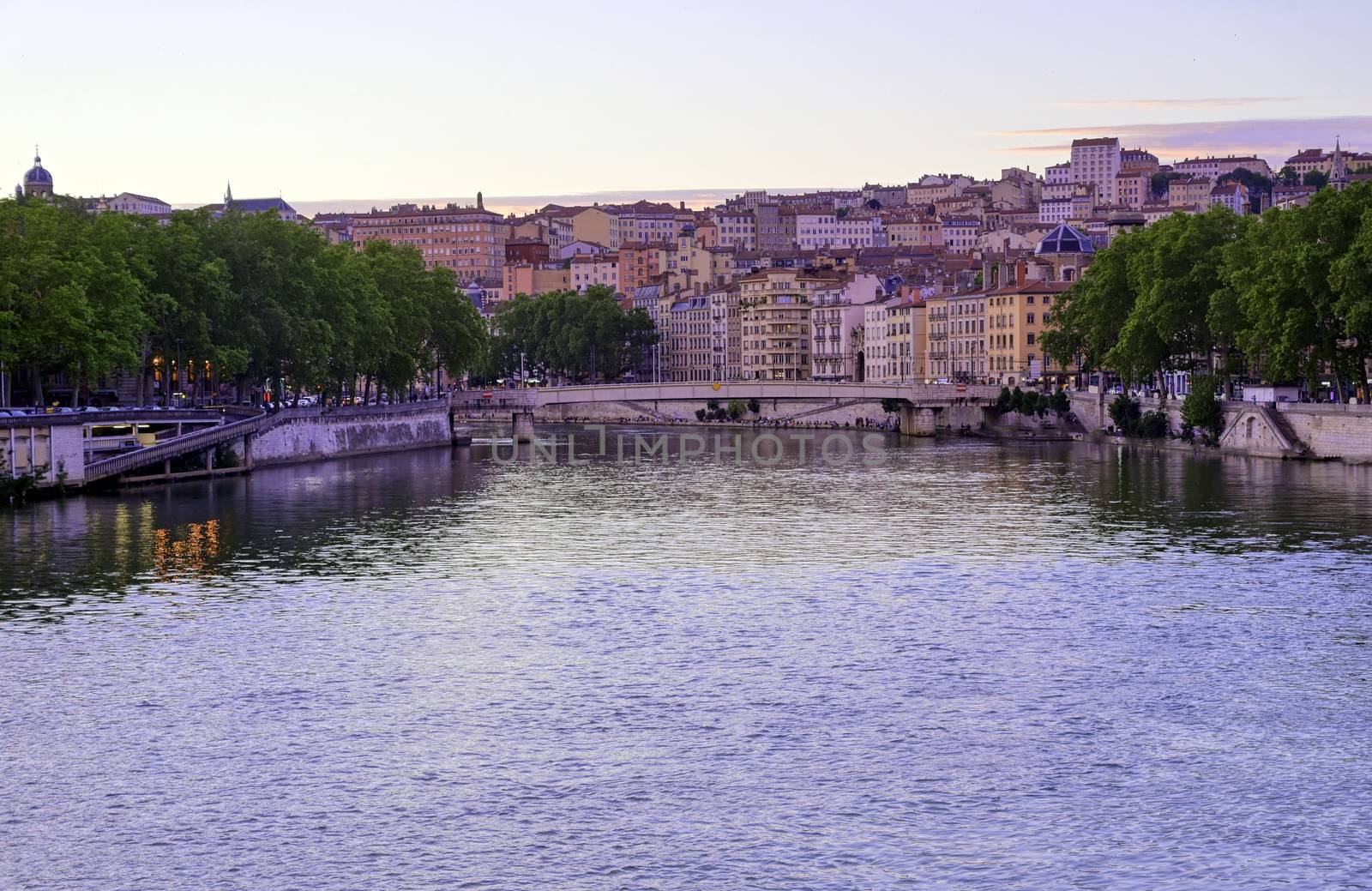 A view of Lyon, France along the Saône river at sunset.