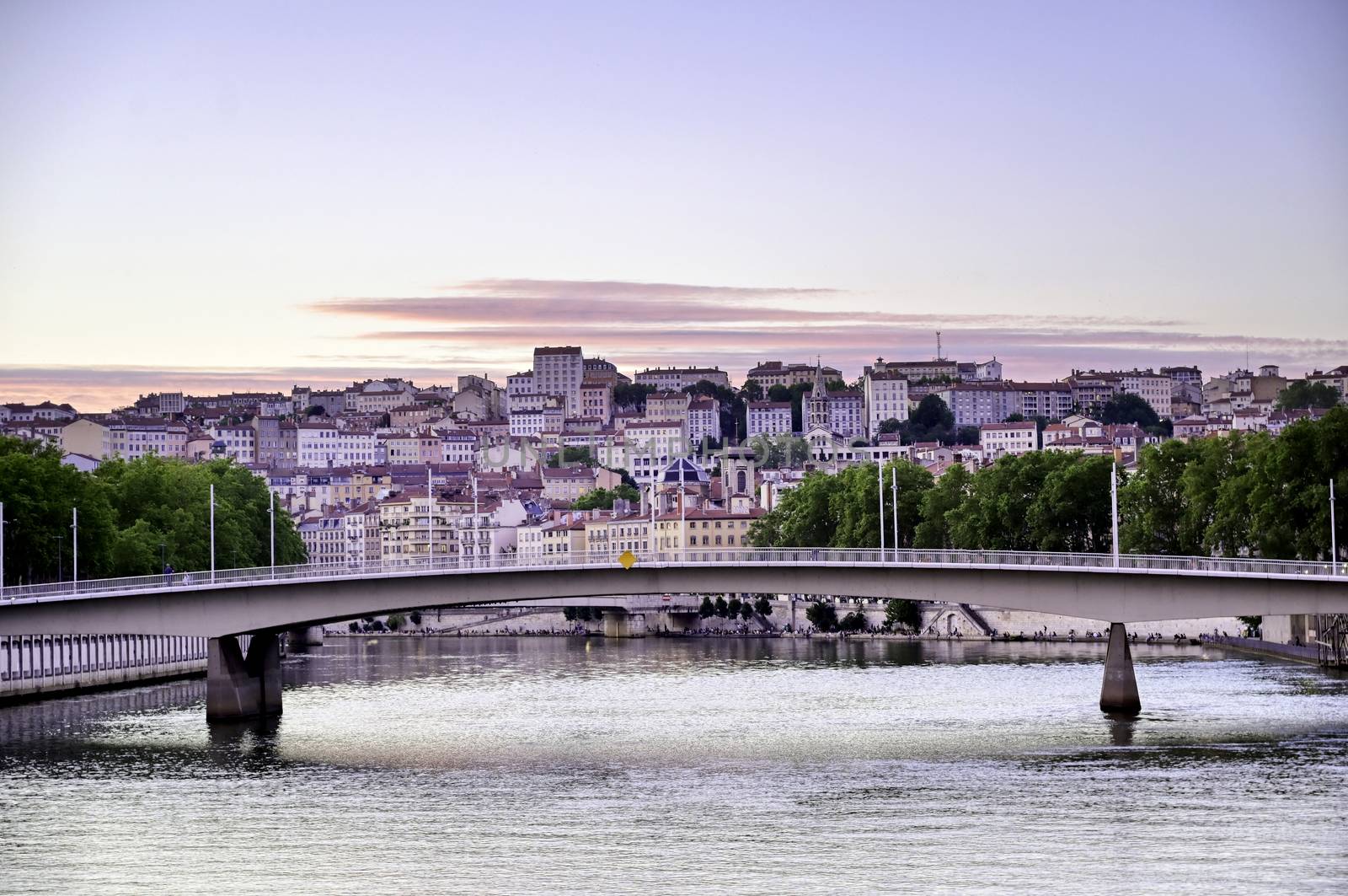 A view of Lyon, France along the Saône river at sunset.