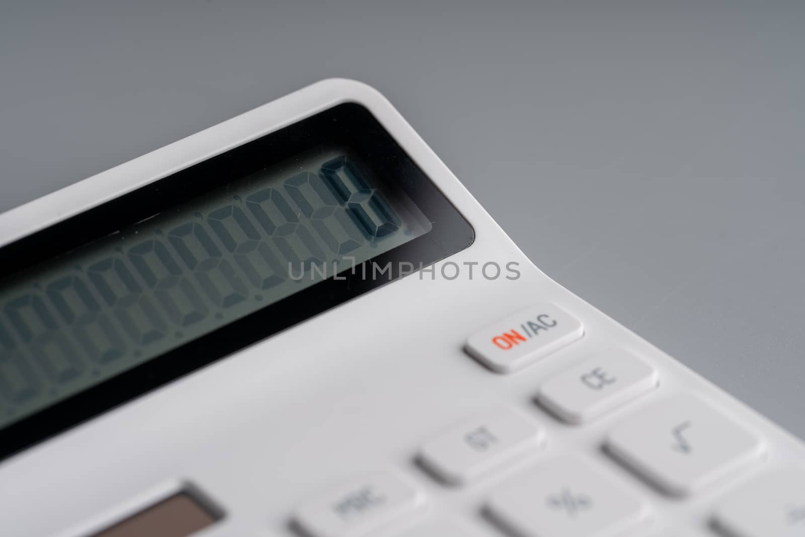 White calculator on grey background for education & business con by Alicephoto