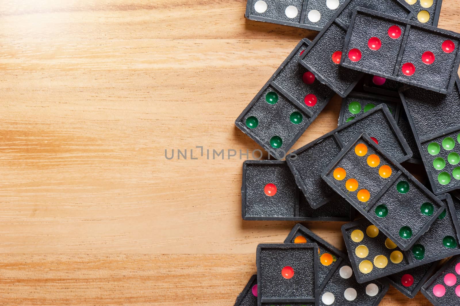 Dominoes on wooden table. Dominoes is a game played with rectangular "domino" tiles.