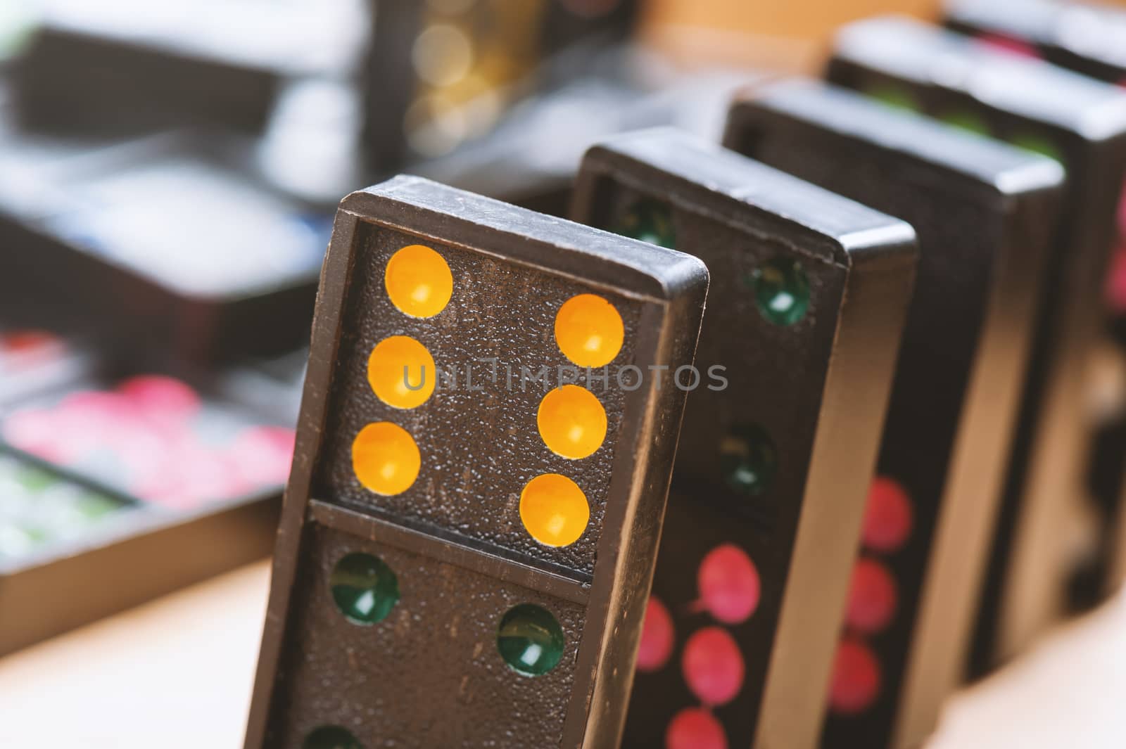 Dominoes on wooden table. Dominoes is a game played with rectangular "domino" tiles.