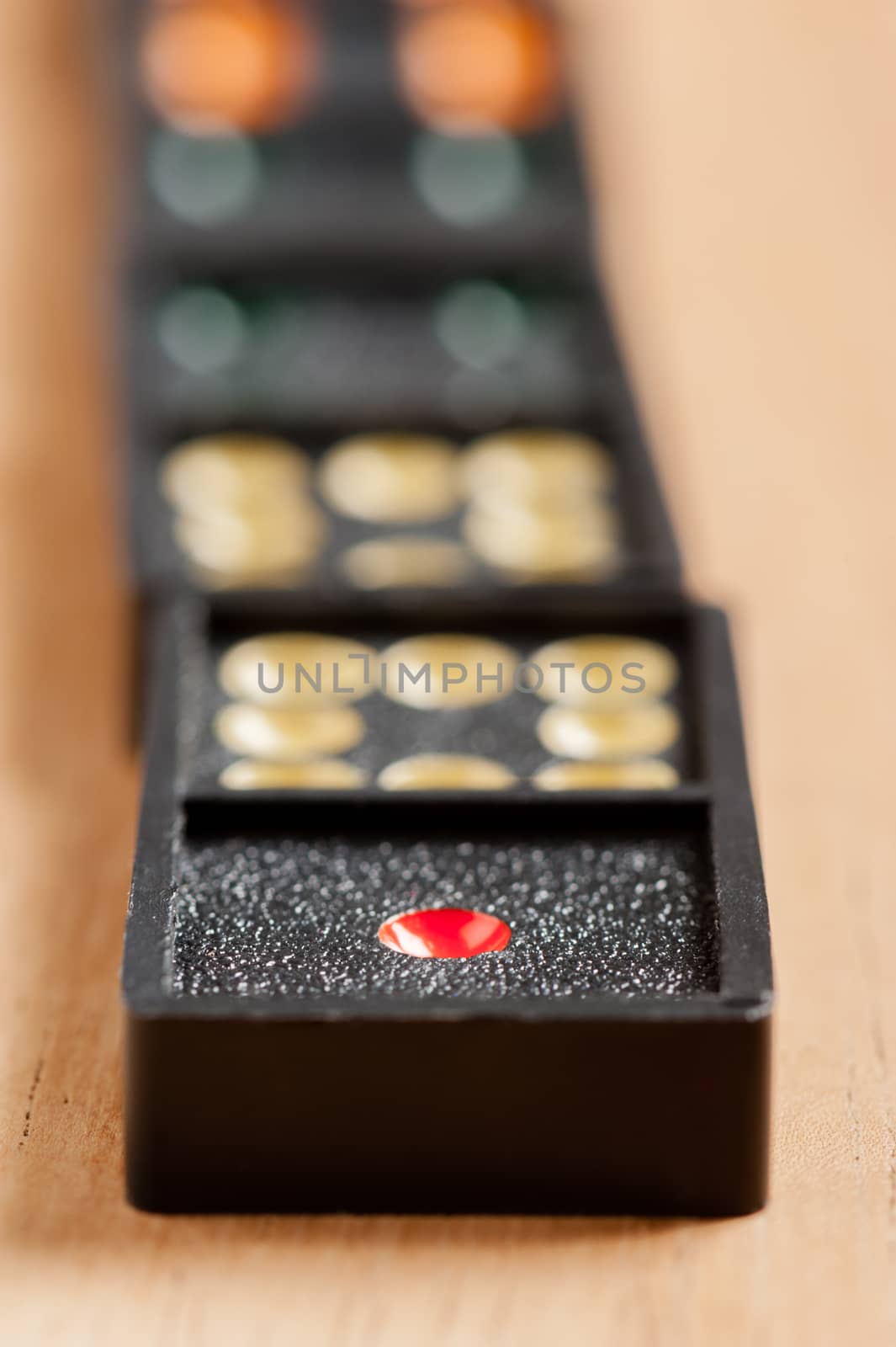 Dominoes on wooden table. Dominoes is a game played with rectangular "domino" tiles.