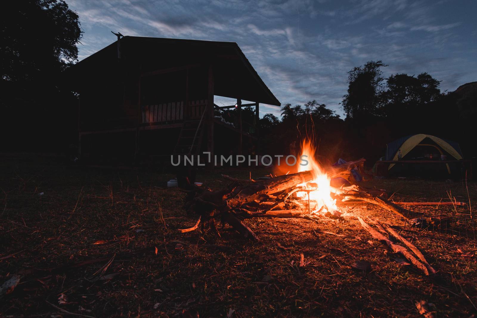 Bonfire with shadows of houses and tents With the morning light by suthipong