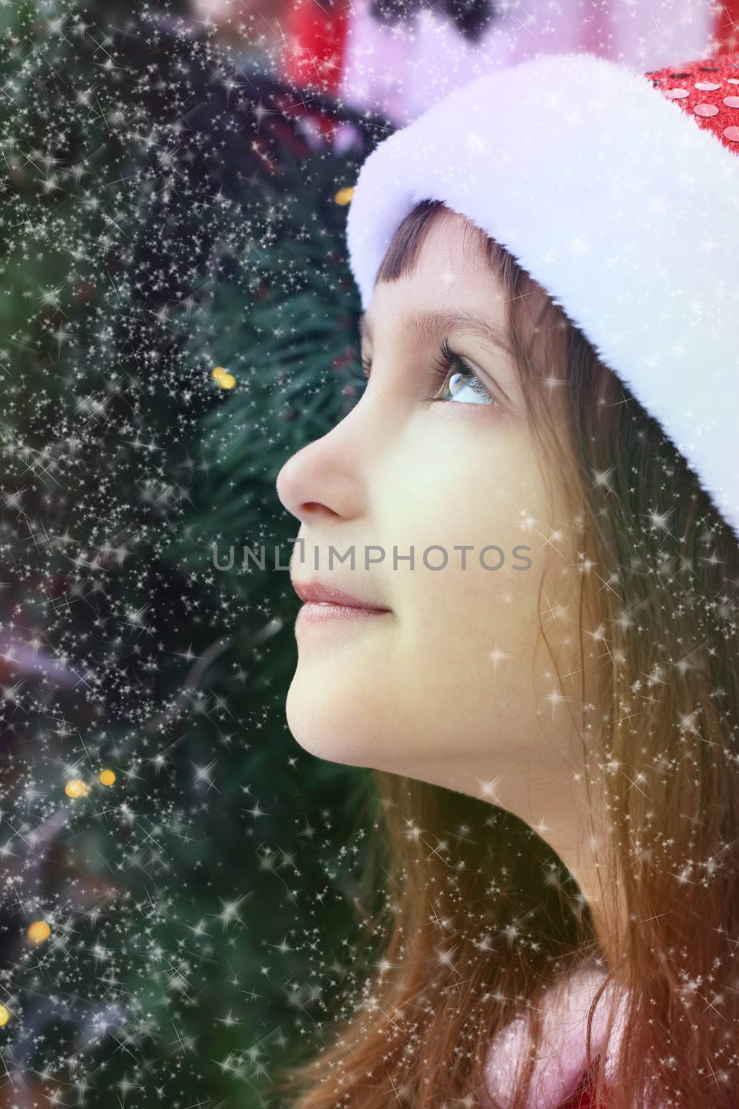 Outdoors portrait of girl looking up. Winter, Christmas time.