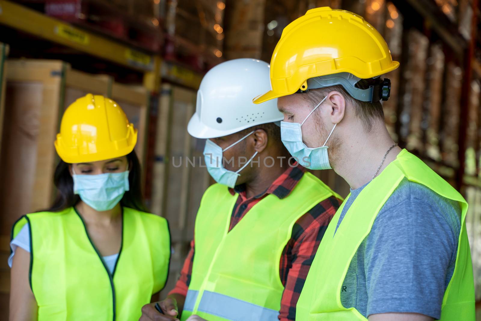 Warehouse workers wearing protective mask to Protect Against Covid-19 by Visoot