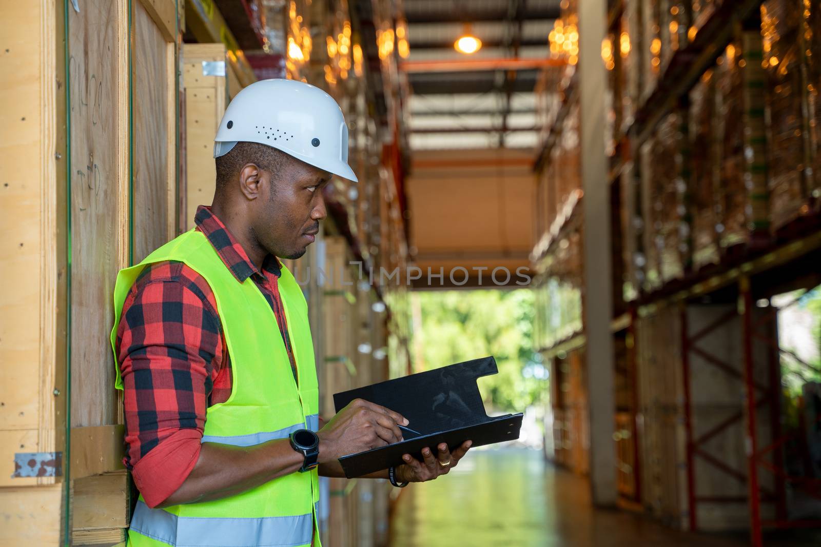 Portrait warehouse workers holding a clipboard working in a warehouse.