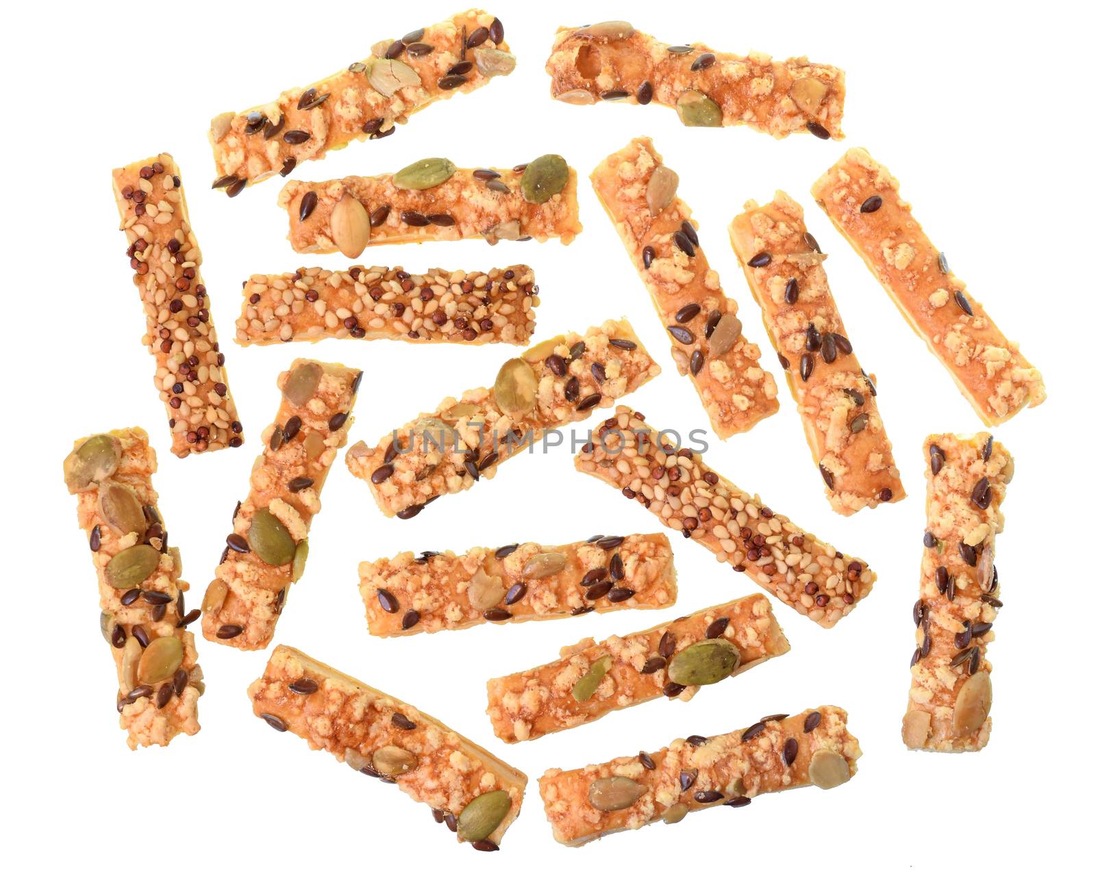 Mini seeded straws topped with cheese and seeds sunflower, pumpkin, linseeds isolated on a white background.