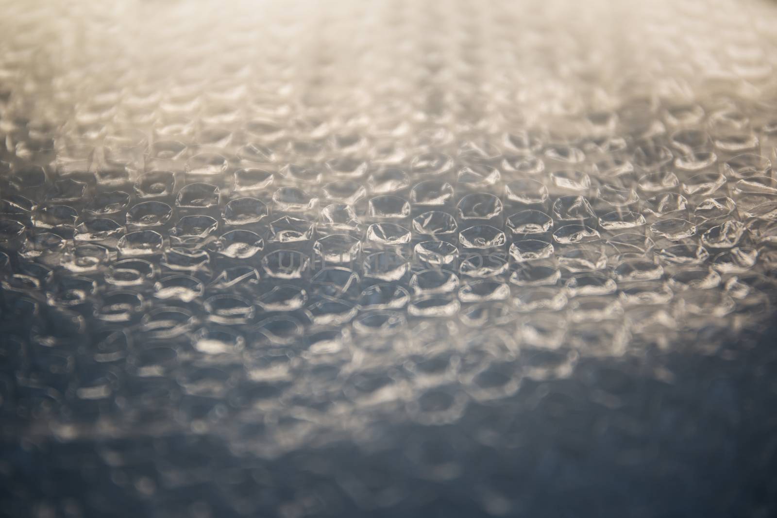 Bubble wrap sheet shot in selective focus with light effect by robbyfontanesi