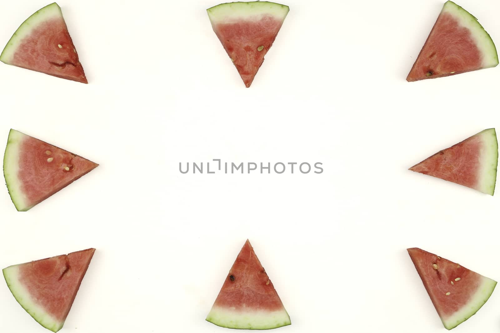 Triangular isolated slices of watermelon forming geometric games for copy space on a white background