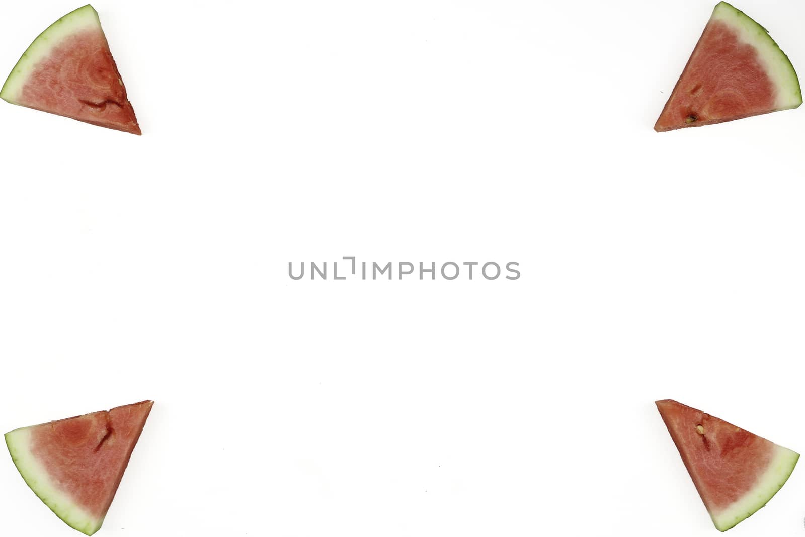 Triangular isolated slices of watermelon forming geometric games for copy space on a white background
