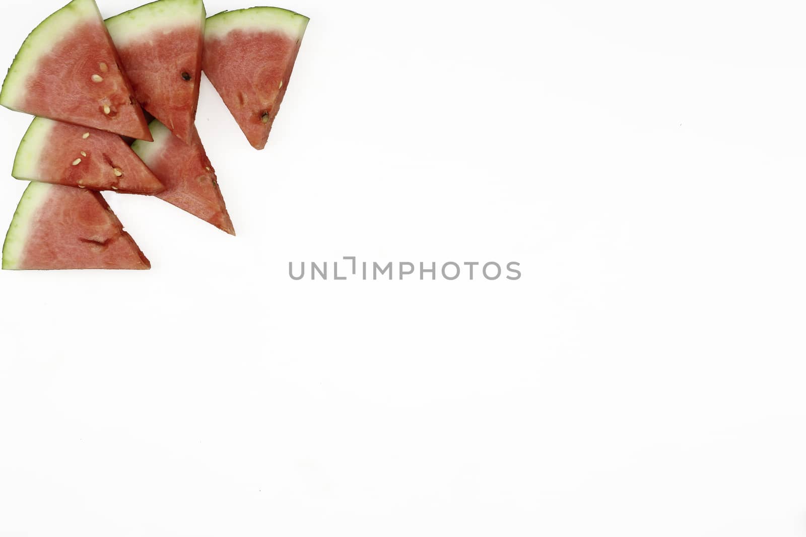 Triangular isolated slices of watermelon forming geometric games for copy space on a white background by robbyfontanesi