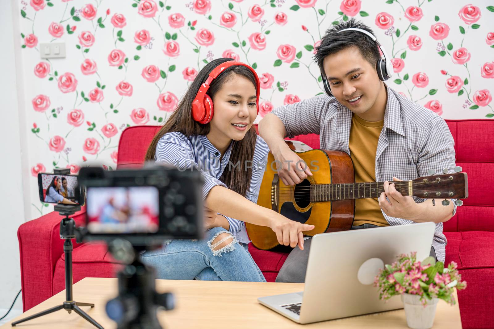 Asian Vlogger of married couple playing and sharing the music to by Tzido
