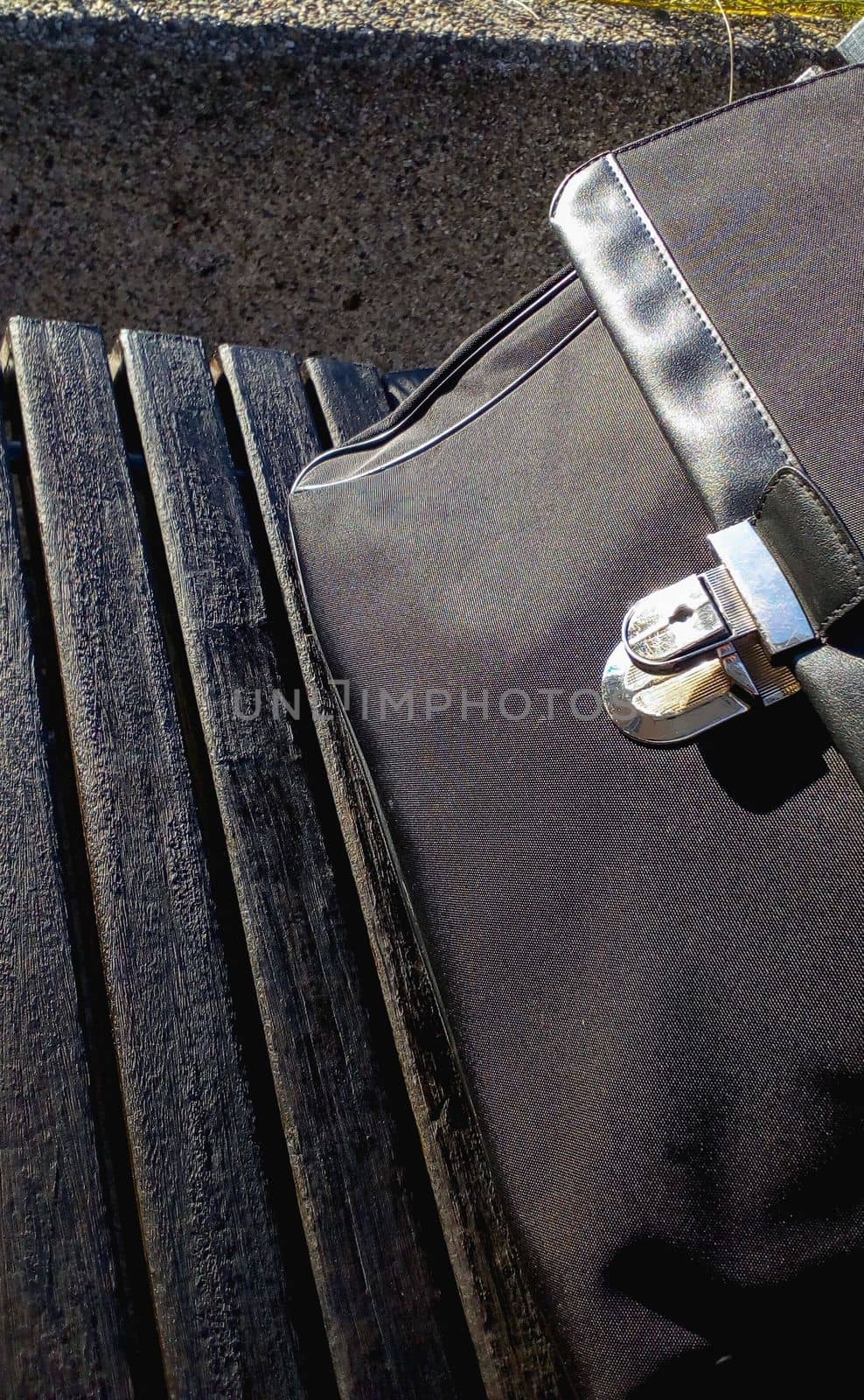 wooden bench with a black businessman briefcase