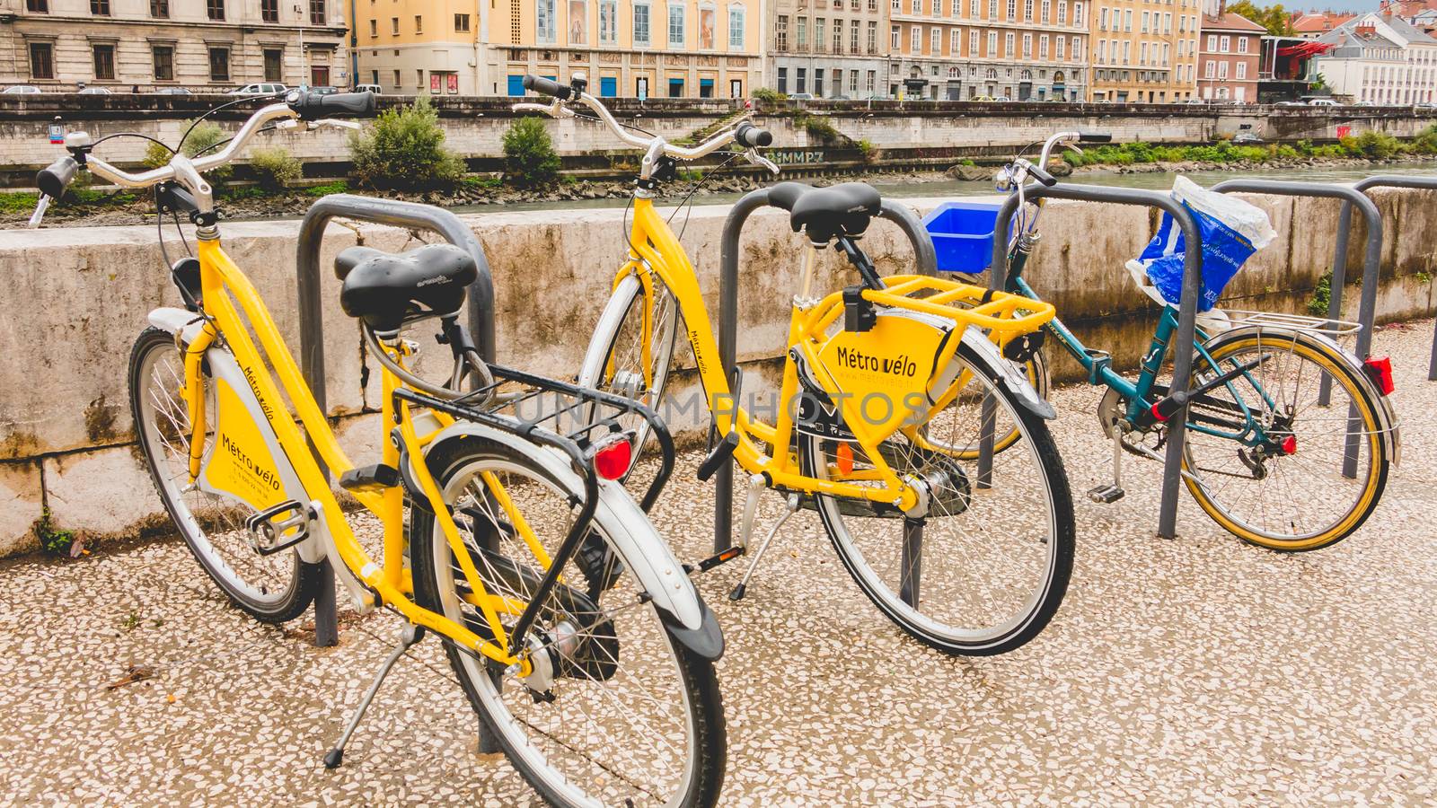 Grenoble, France - September 17, 2016 : Shared bikes are lined up in the streets of Grenoble, France. The successful Metrovelo service, launched in 2004, has over 800 stations and 4,000 bikes throughout Grenoble