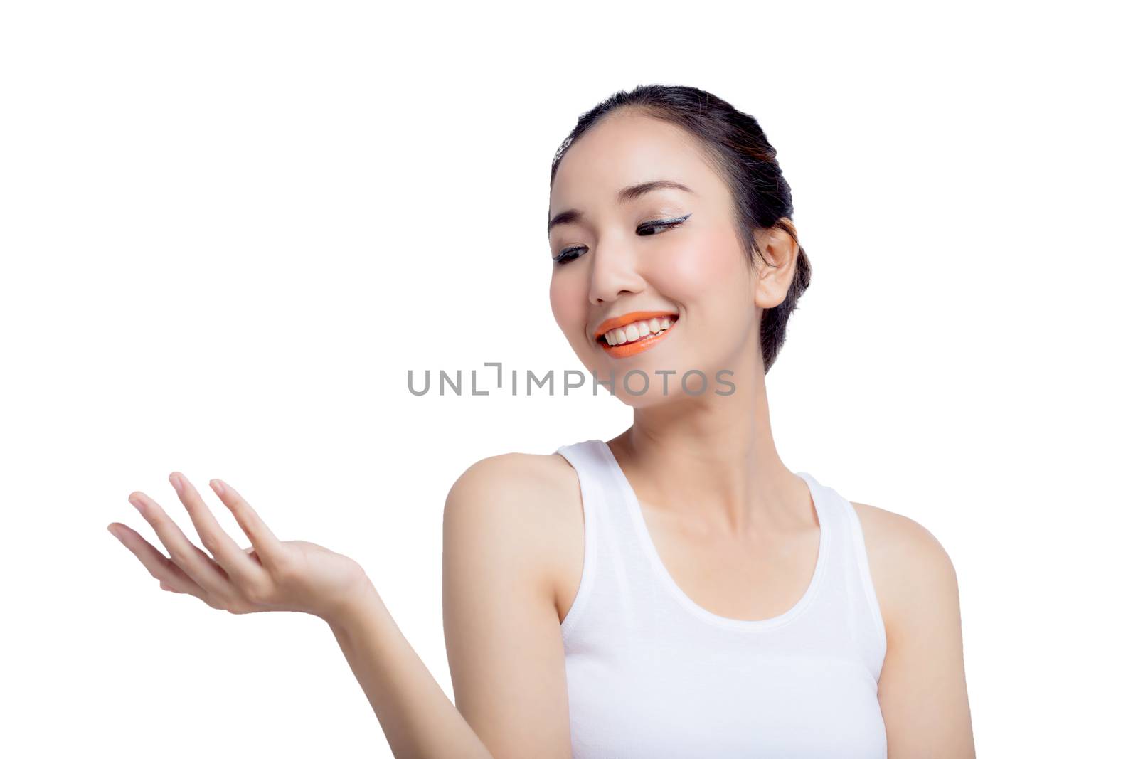 Beauty spa woman with perfect face skin Portrait. Beautiful Spa Girl showing empty copy space on the open hand palm for text. Proposing a product. Gesture for advertisement. Isolated on white background