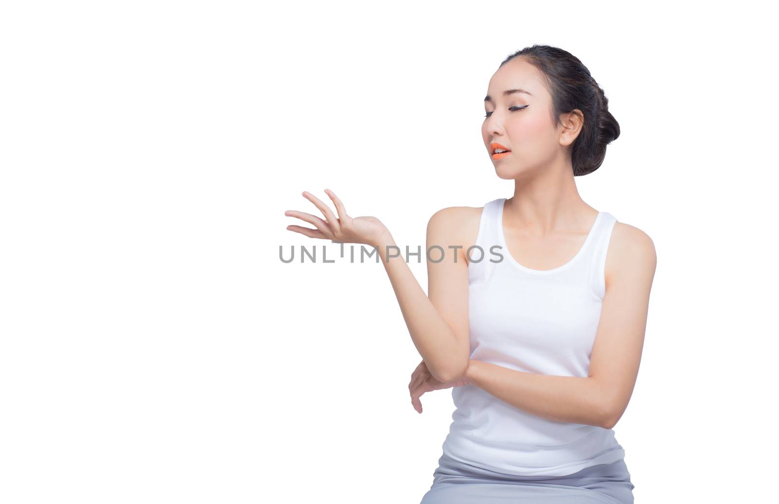 Beauty spa woman with perfect face skin Portrait. Beautiful Spa Girl showing empty copy space on the open hand palm for text. Proposing a product. Gesture for advertisement. Isolated on white background