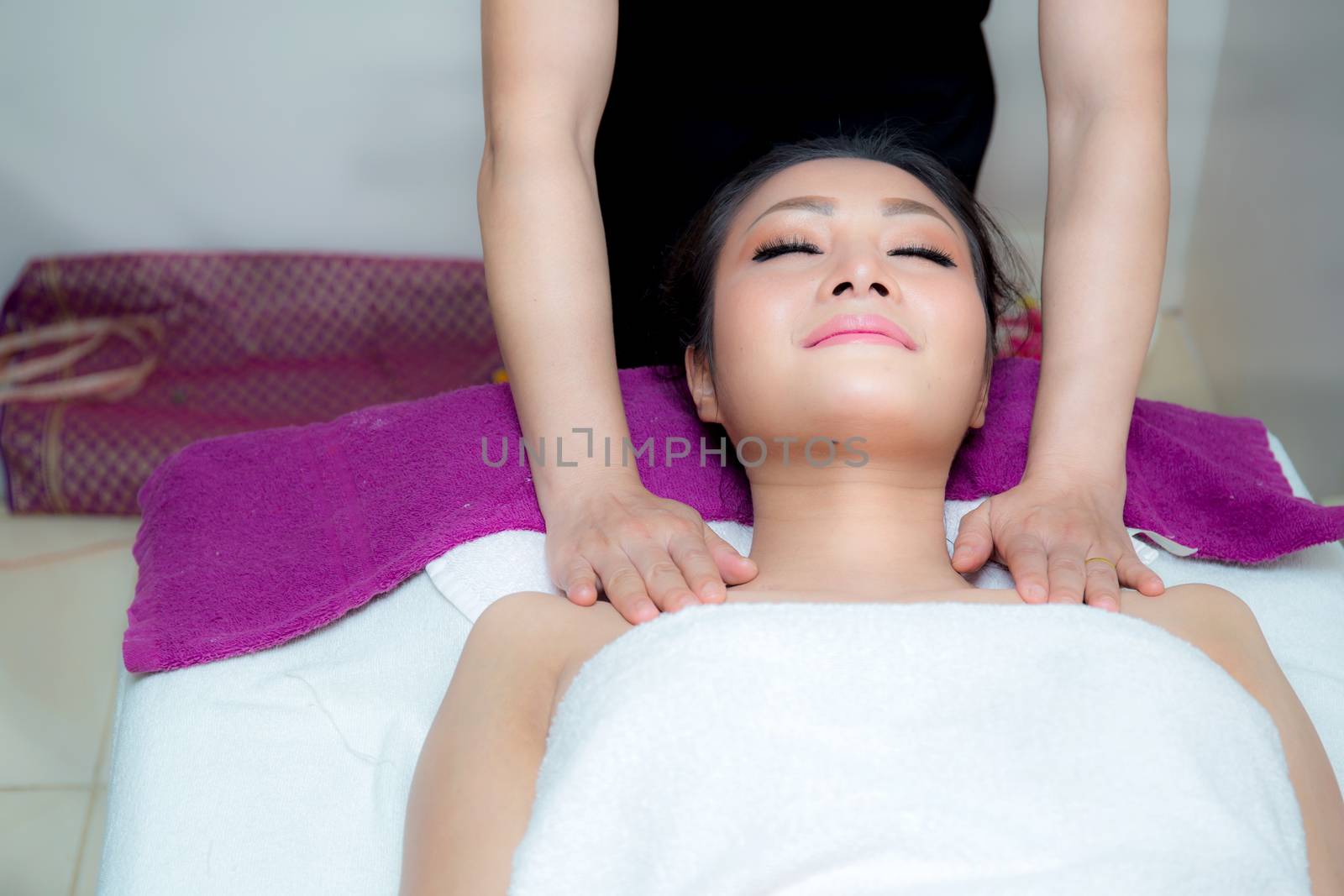 Beautiful woman is getting a facial massage in the spa salon by nnudoo