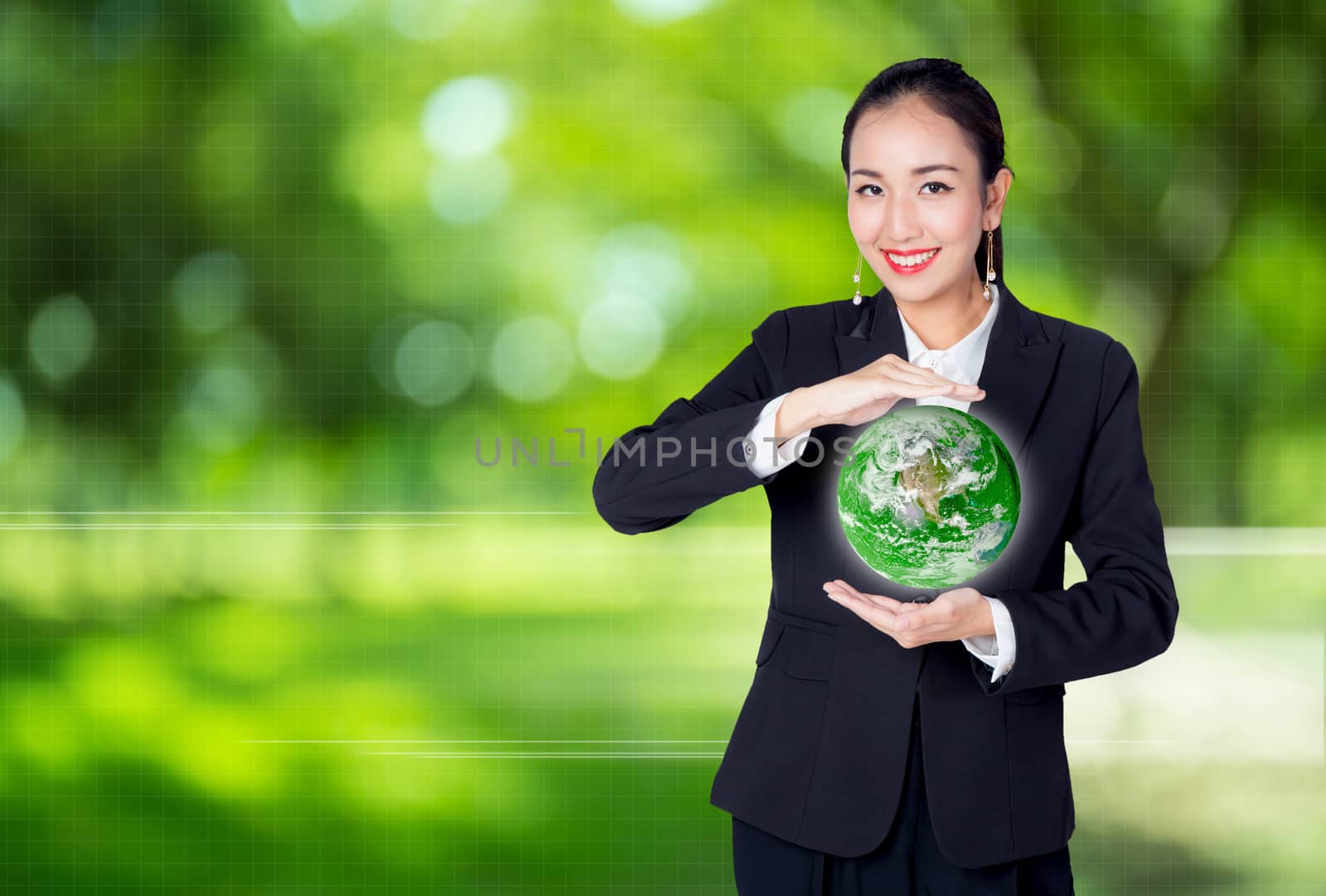 businesswoman is hand holding a green earth, environment concept