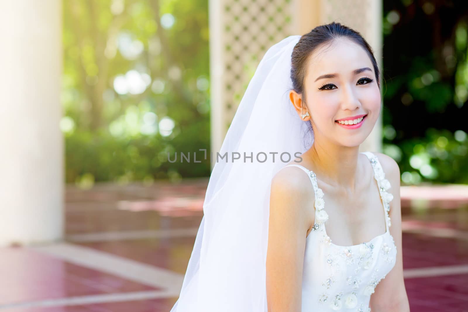 bride is sitting with flowers. Beautiful Young woman posing in p by nnudoo