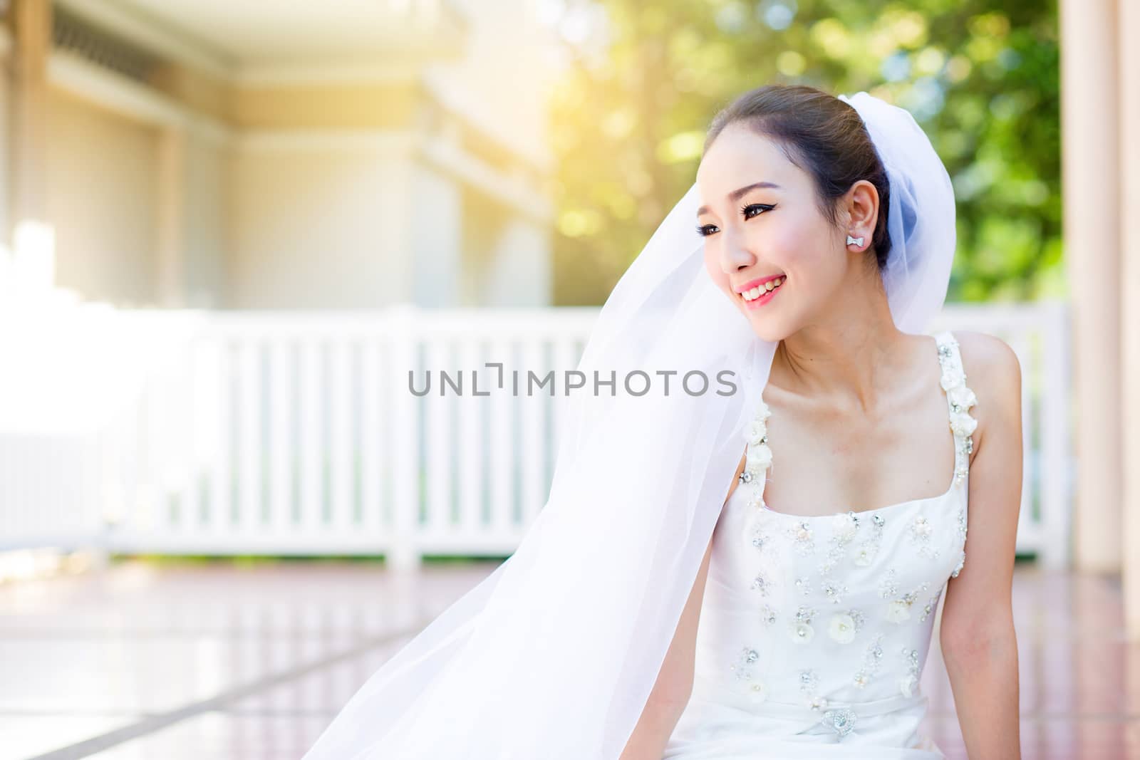 bride is sitting with flowers. Beautiful Young woman posing in p by nnudoo