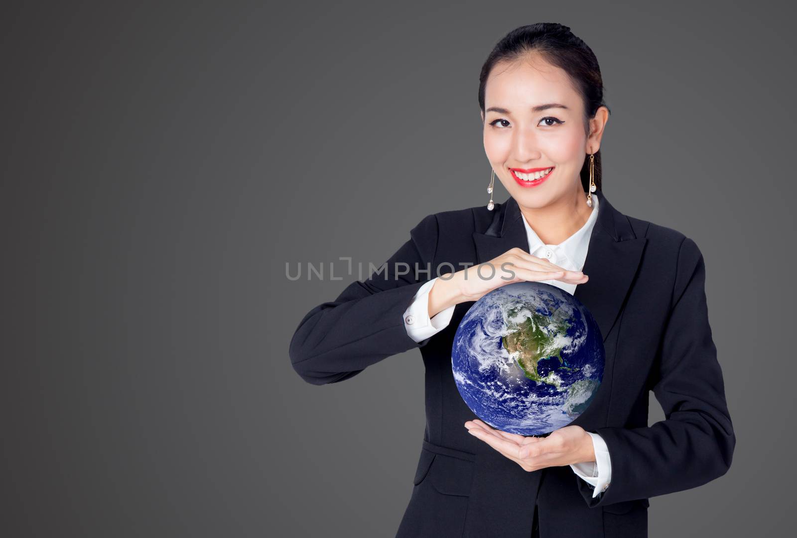 Businesswoman holding the world in the palm of hands concept for global business, communications, politics or environmental conservation, Elements of this image furnished by NASA