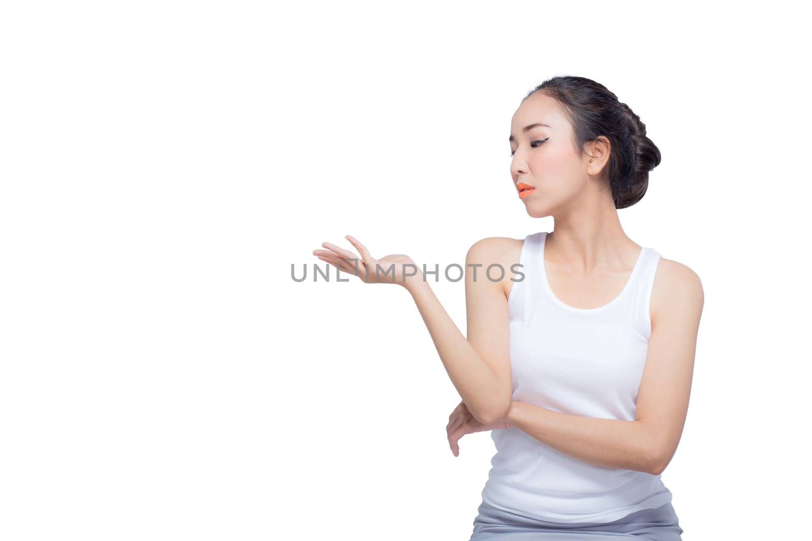 Beauty spa woman with perfect face skin Portrait. Beautiful Spa Girl showing empty copy space on the open hand palm for text. Proposing a product. Gesture for advertisement. Isolated on white background