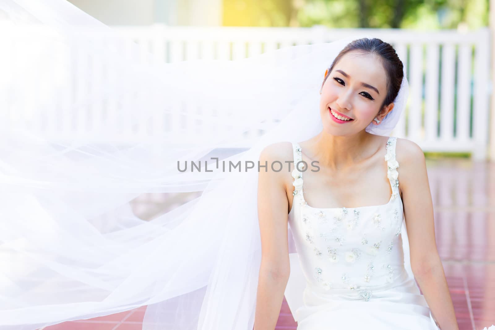 bride is sitting with flowers. Beautiful Young woman posing in p by nnudoo