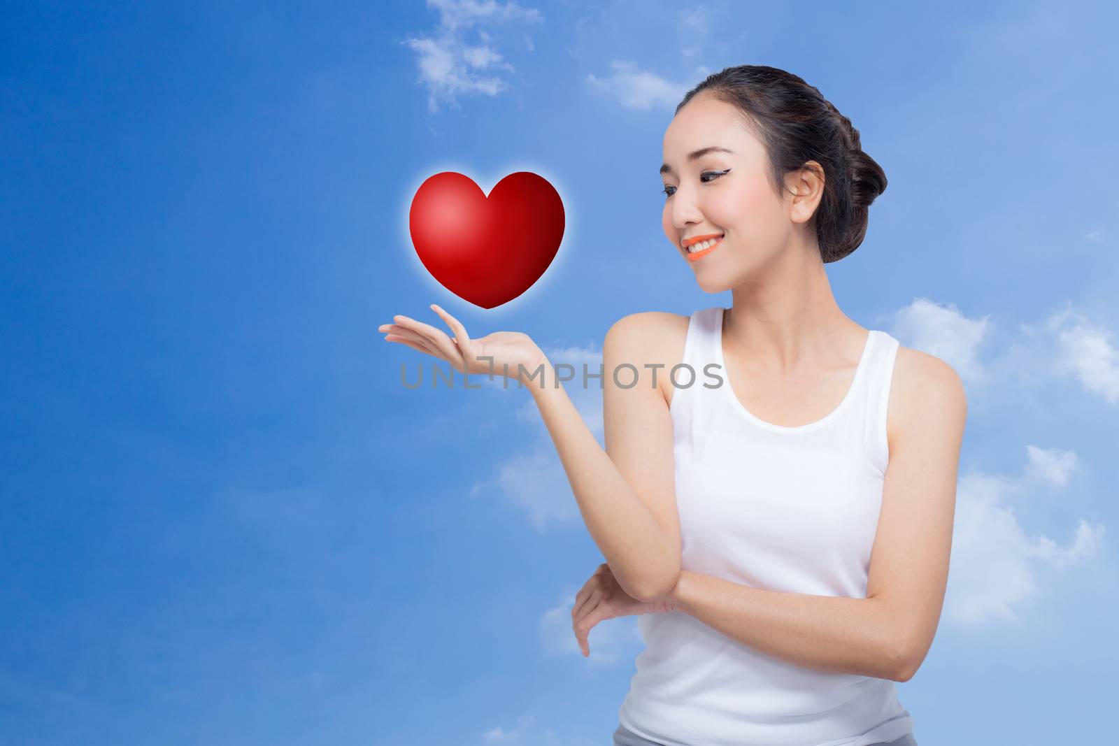 Beauty spa woman with perfect face skin Portrait. Beautiful Spa Girl showing empty copy space on the open hand palm for text. Proposing a product. Gesture for advertisement. Isolated on white background