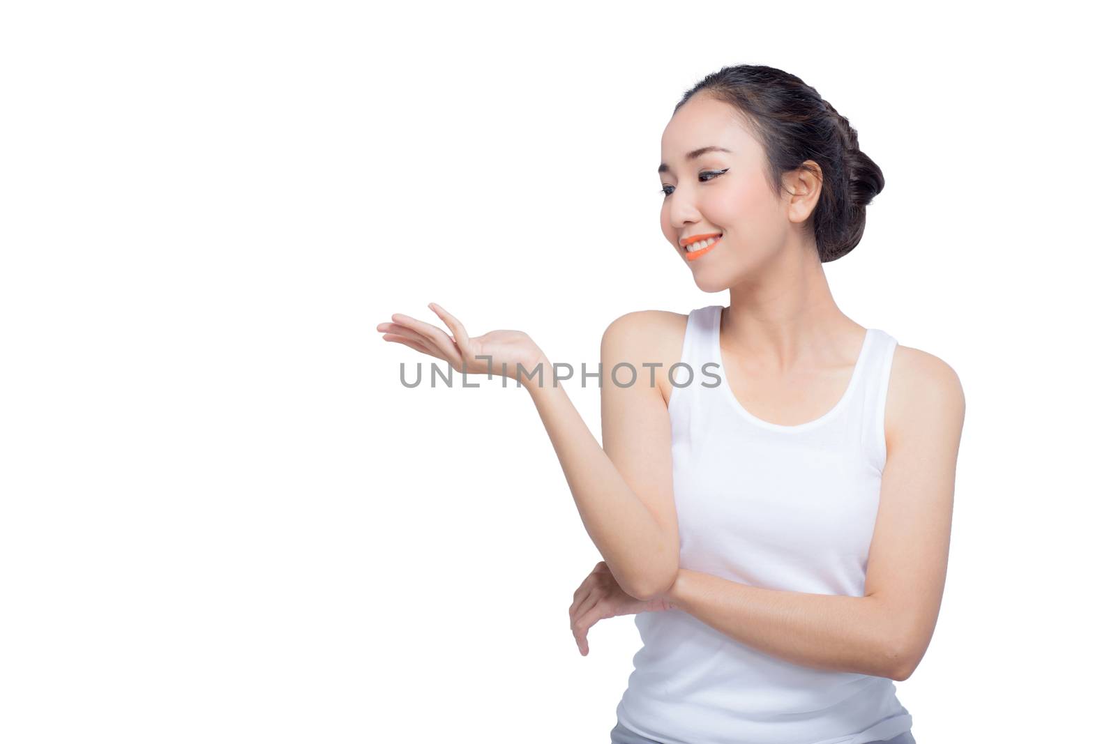 Beauty spa woman with perfect face skin Portrait. Beautiful Spa Girl showing empty copy space on the open hand palm for text. Proposing a product. Gesture for advertisement. Isolated on white background