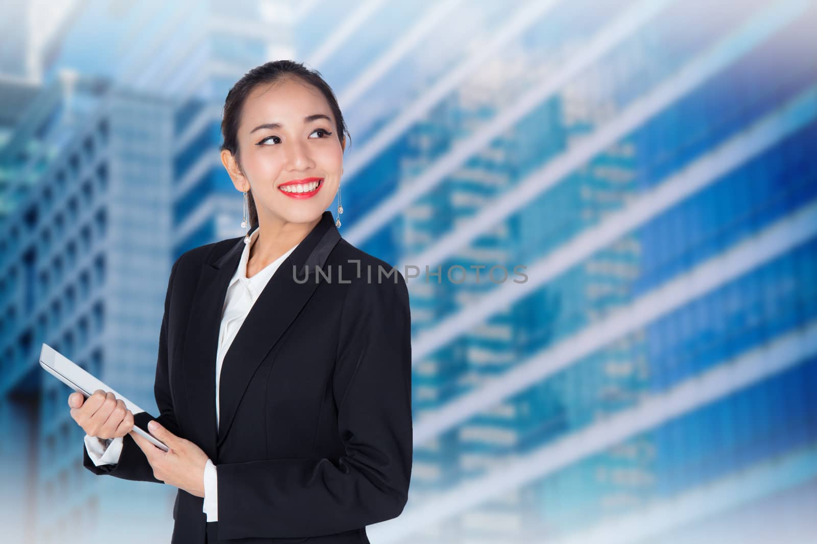 Young woman holding using touch pad tablet computer, model is a asian beauty