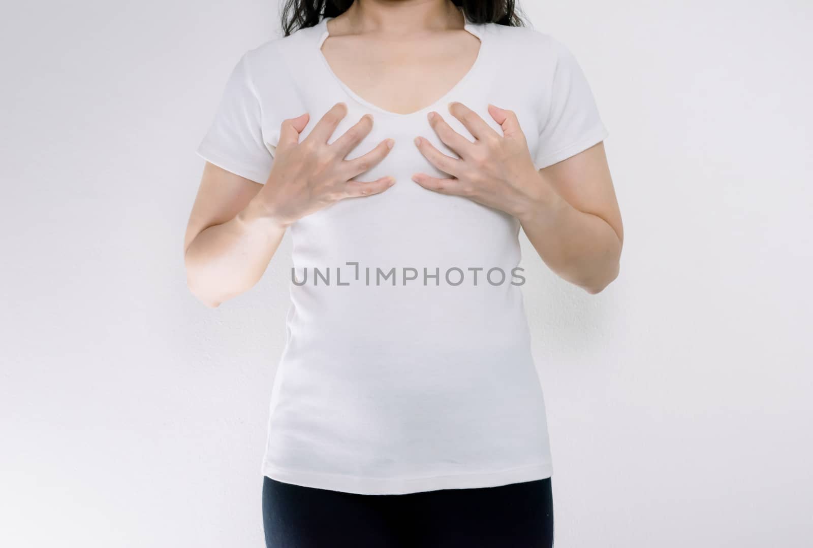 Young woman wearing tshirt holding hands on breast small