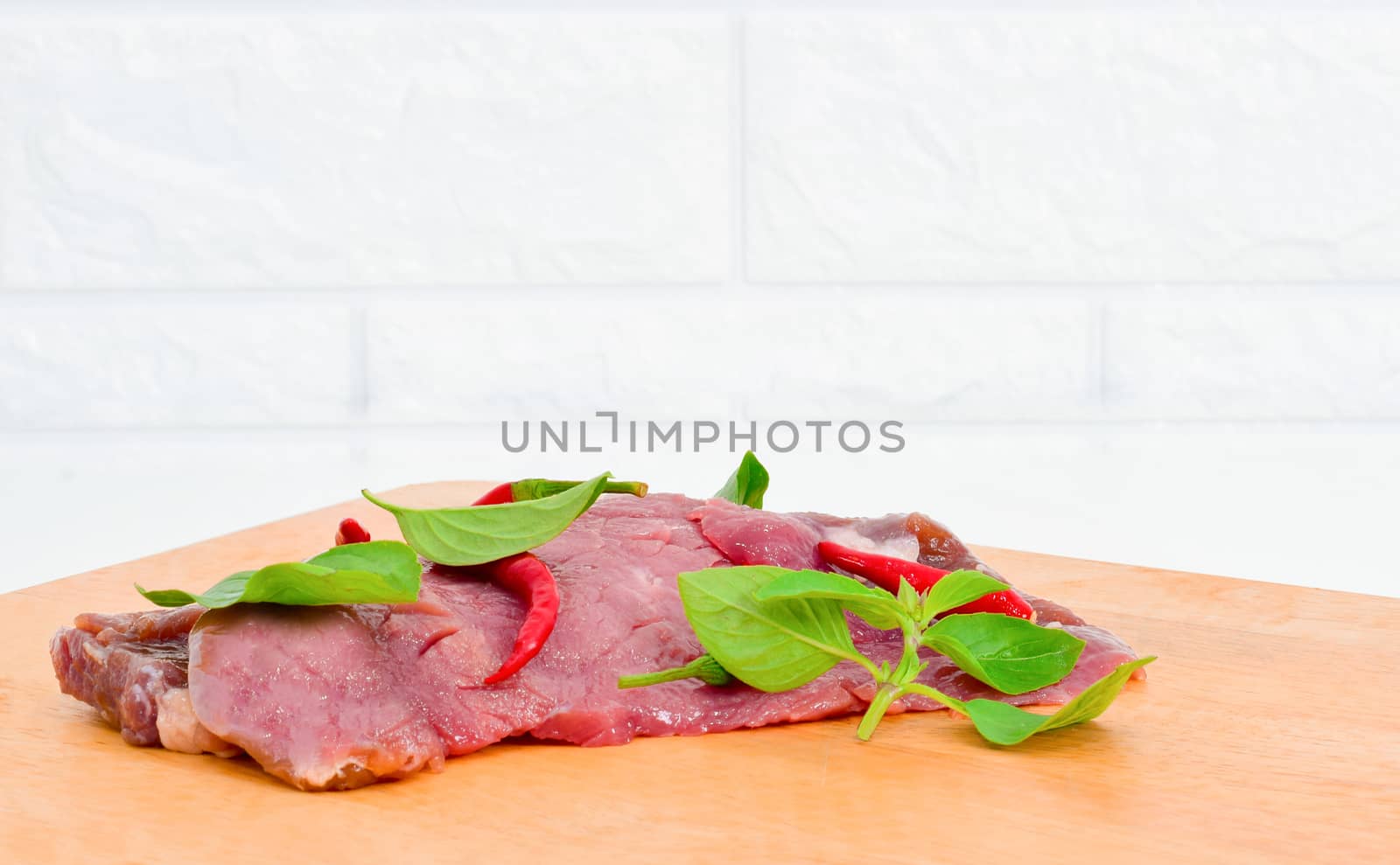 Fresh chili meat on a wooden cutting board by sompongtom