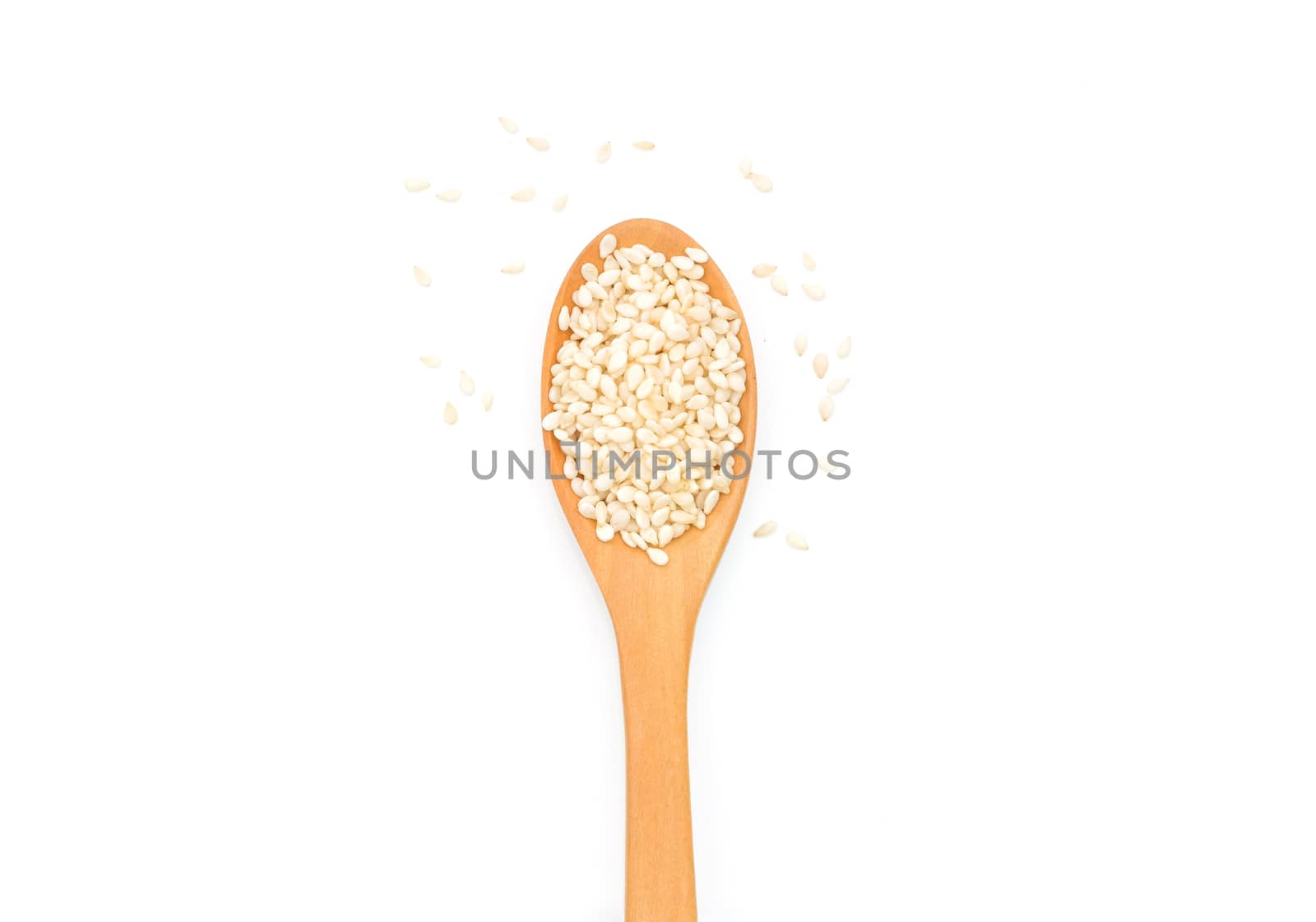 White sesame seeds in wooden scoop on white background by sompongtom