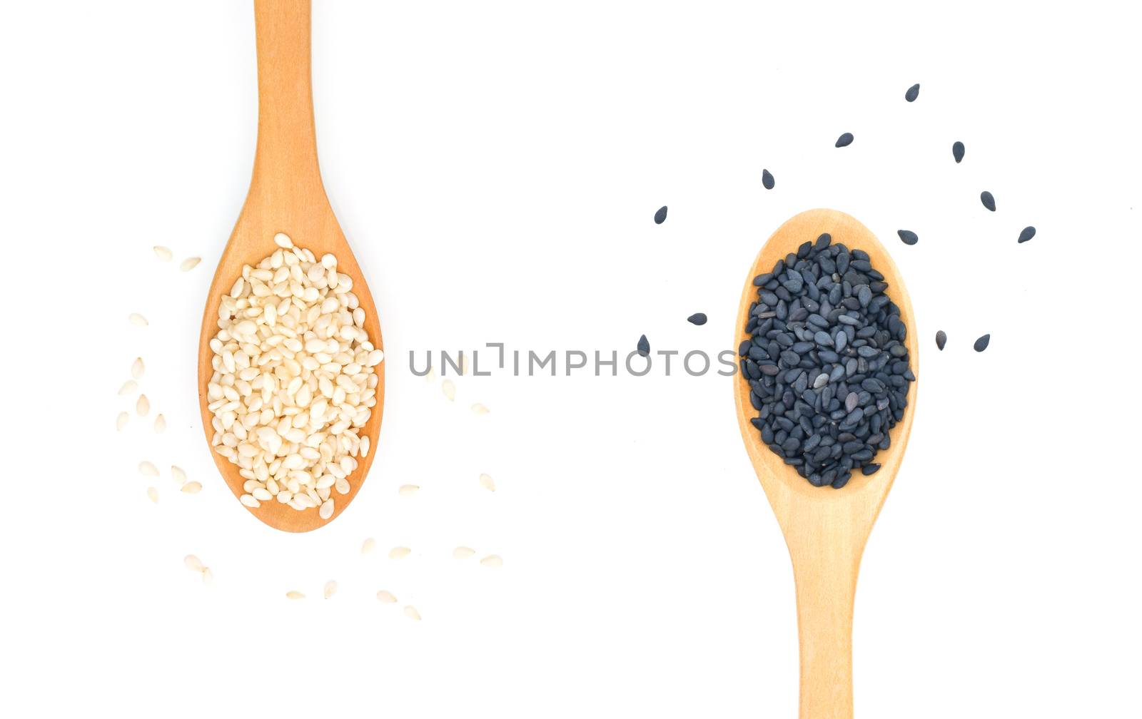 White and Black sesame seeds in wooden scoop on white background by sompongtom