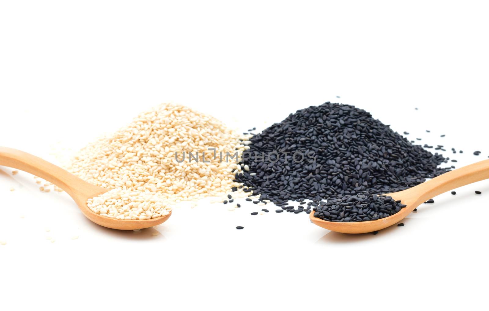 White and Black sesame seeds in wooden scoop on white background by sompongtom