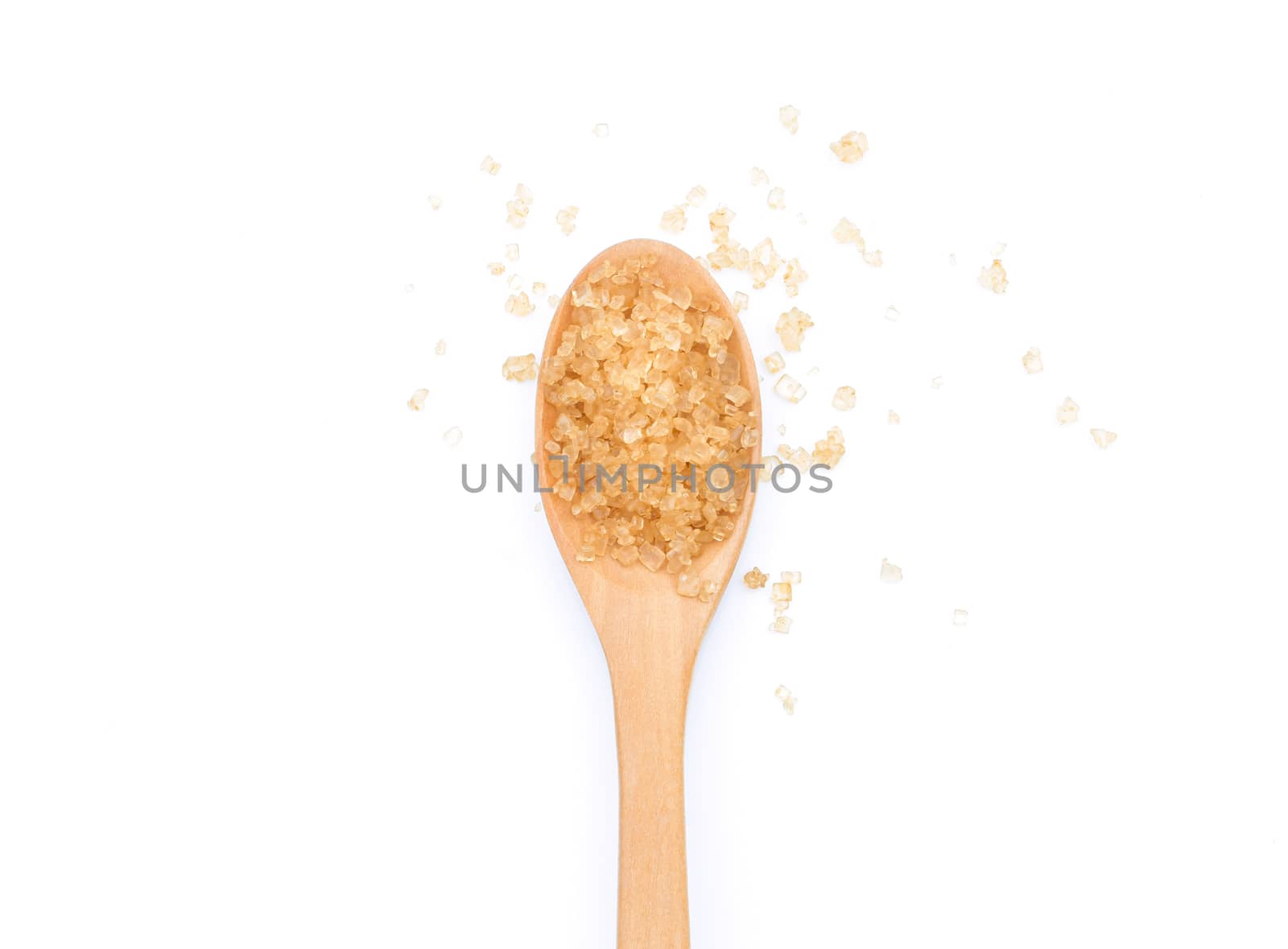 Brown sugar in wooden scoop on white background