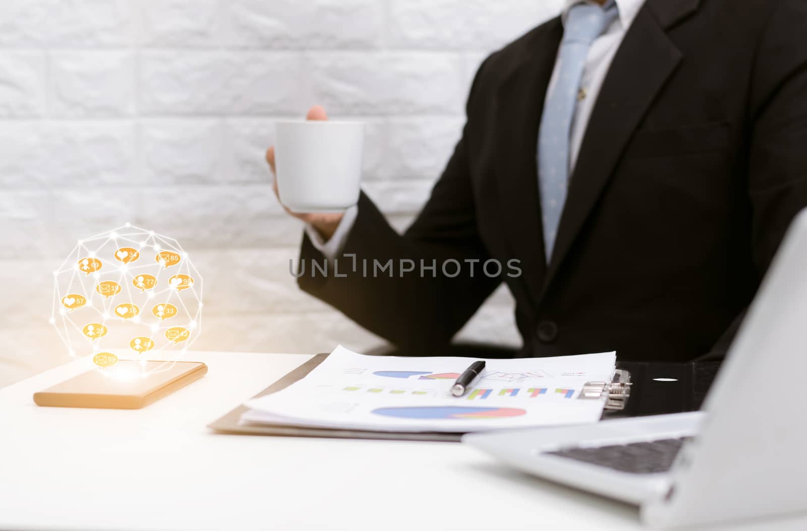 Businessman online community coffee break relax on laptop at his desk.