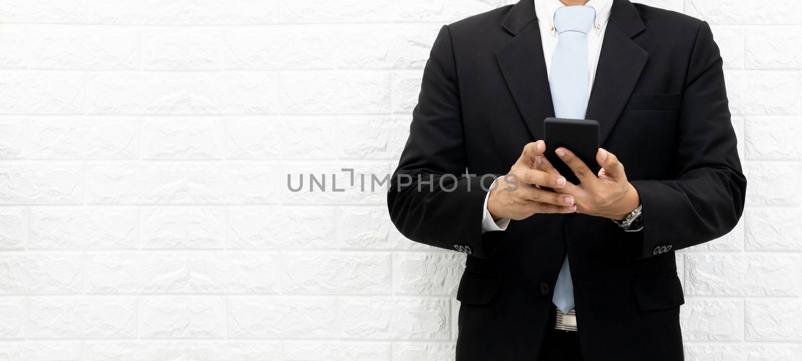 Business men hold smartphones to check information at the office by sompongtom