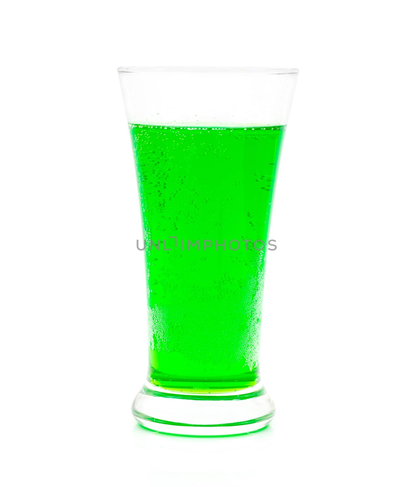 Green sparkling water in a glass on a white background