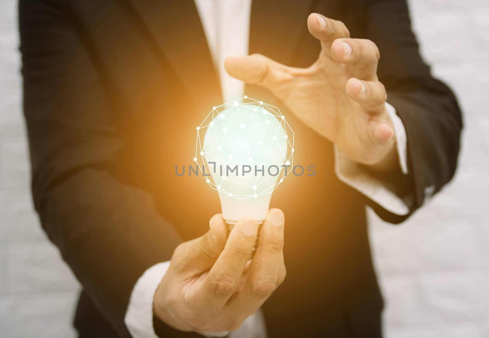 Light bulb new ideas with innovative technology solution concepts hands of the businessman. by sompongtom